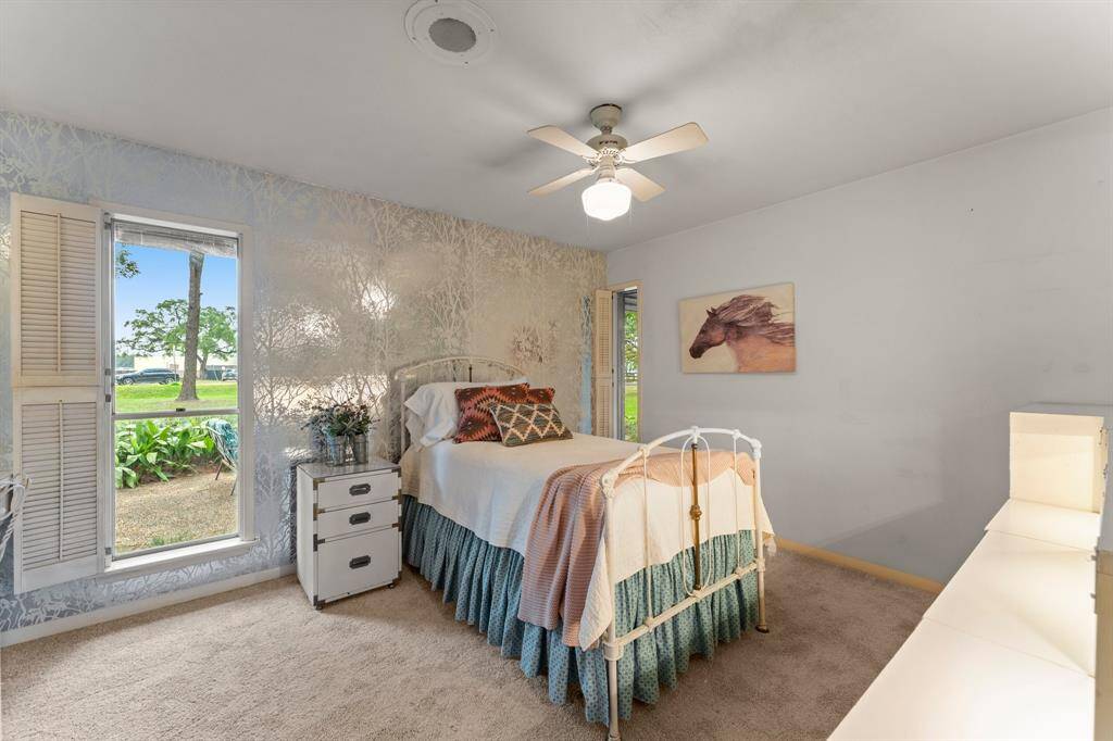 Bedroom 4 with views of side yard.
