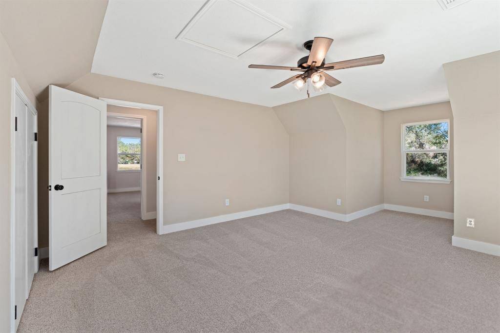 Second floor room/flex-space. Featuring windows on both the east and south for the perfect view overlooking the property and ample storage/closet space.