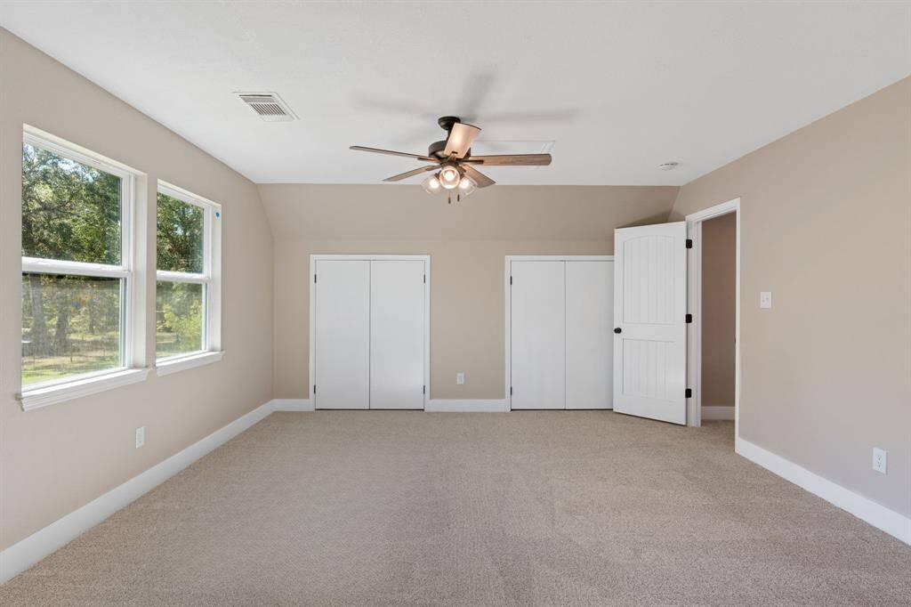 Second floor room/flex-space. Featuring windows on both the east and south for the perfect view overlooking the property and ample storage/closet space.