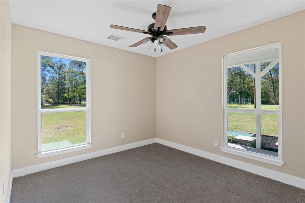 First floor room/flex-space located in the back corner of the home, facing the south and west of the property.
