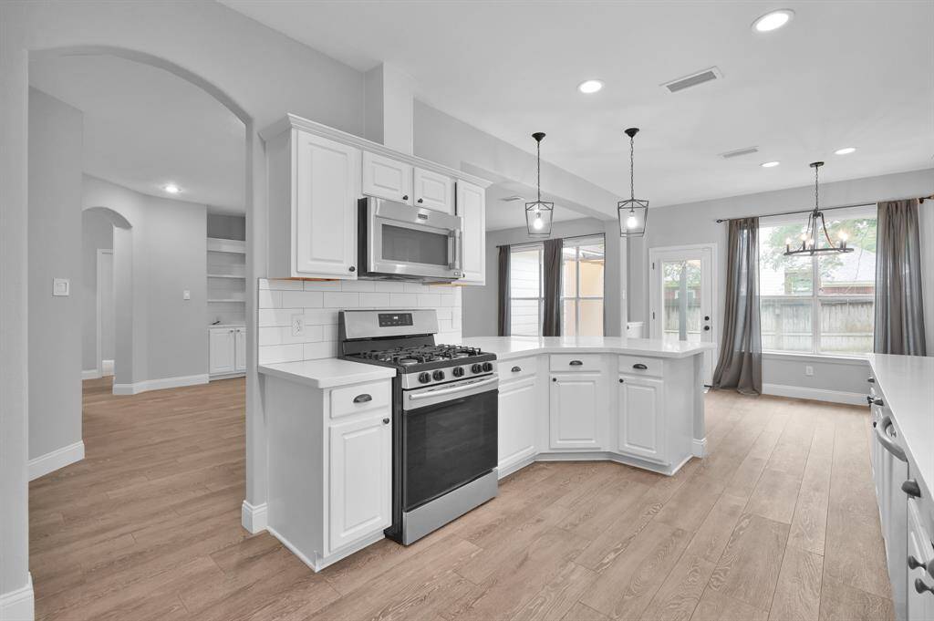 The kitchen offers generous counter and cabinet space, along with a dedicated pantry.