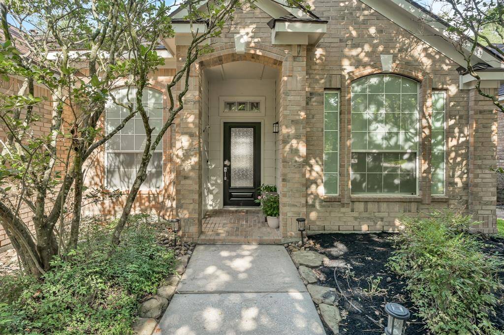 Cozy covered front porch with a freshly stained front door.