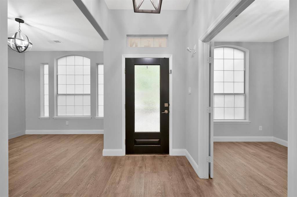 Entering this home you are greeted by tile-look wood flooring, fresh designer paint colors, and the open floor plan.