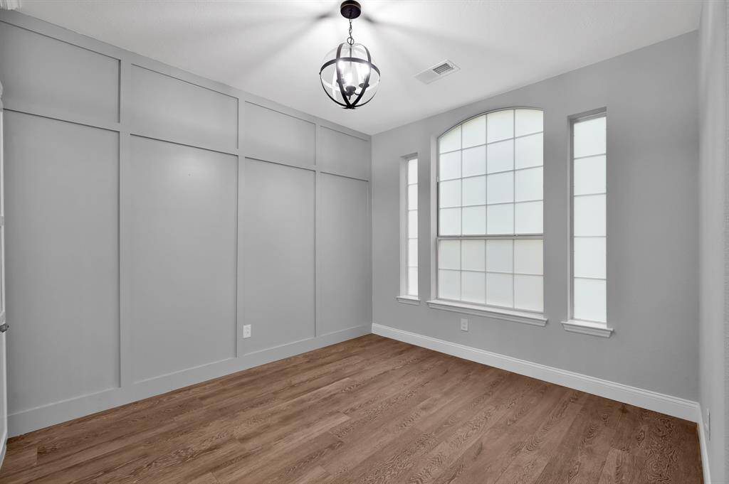 Formal dining room features an elegant board and batten accent wall.