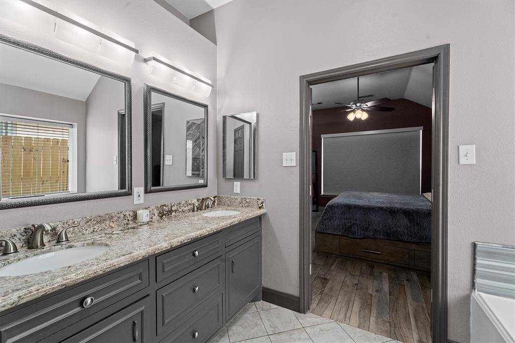 primary en suite bathroom with custom tile shower, soaking tub & double vanity