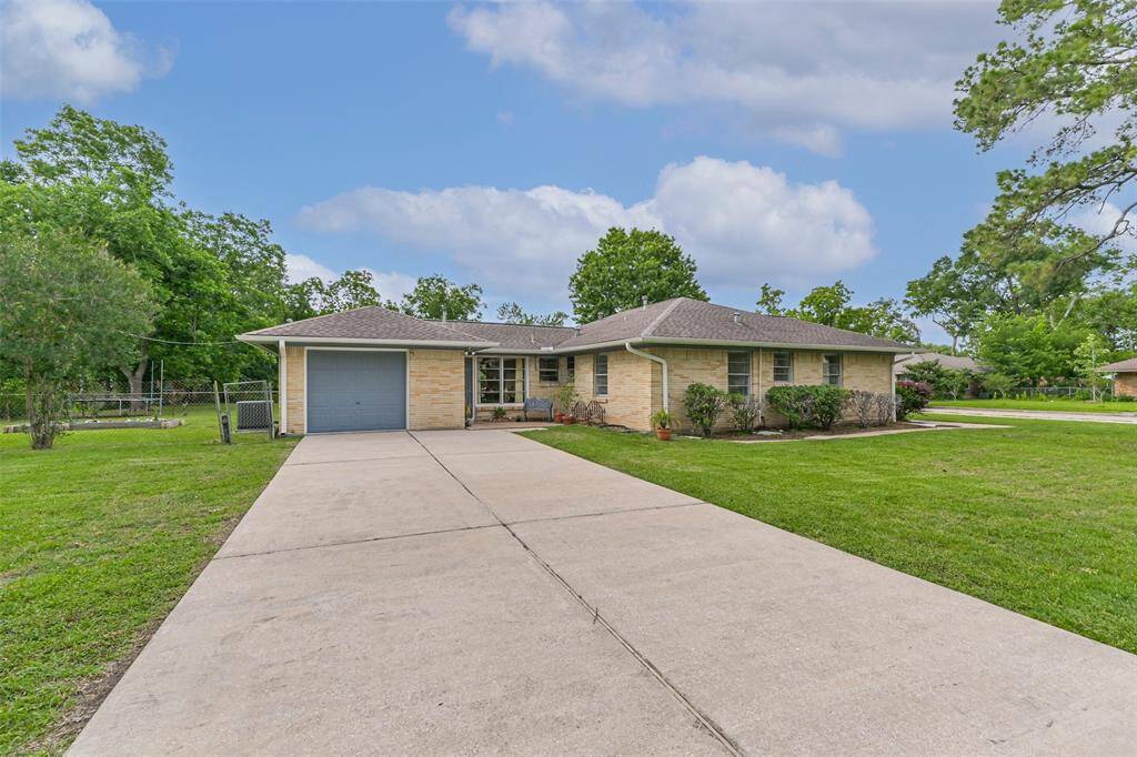 Notice the attractive brick, wide driveway for off-street parking, walkway around the home and massive yard (maintained by Landlords)