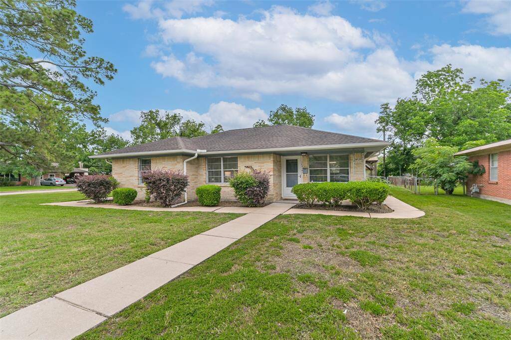 Another glimpse of the brick beauty on a corner lot. Walkway leads to covered front porch
