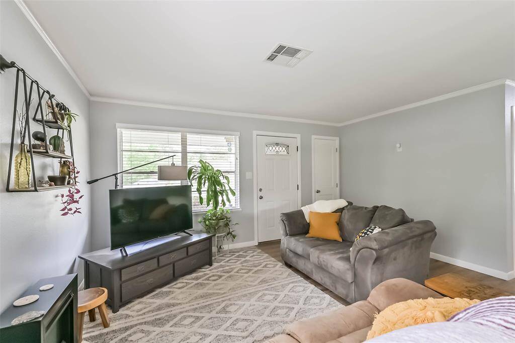Looking from the dining room through living room toward front door. Coat closet conveniently located adjacent to the front door