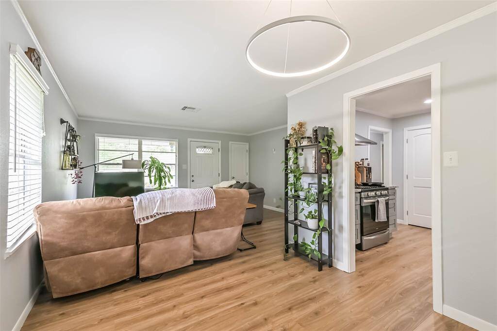 Catch a glimpse of the other window overlooking backyard and cased opening to kitchen