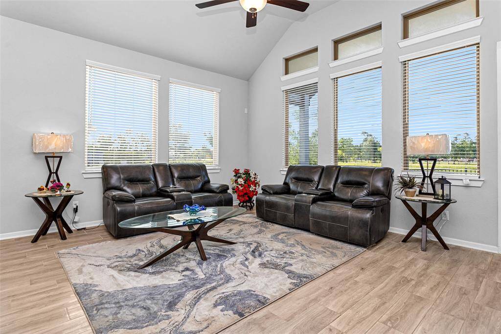 The living room is spacious and filled with an abundance of natural light.