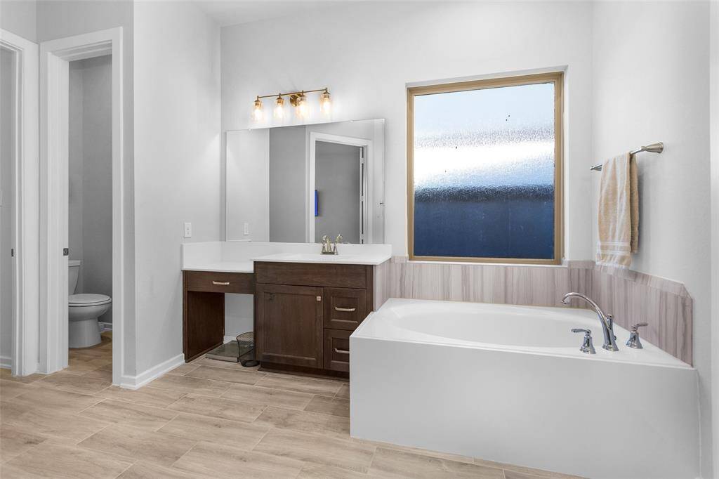 Double sinks provide convenience, while the tub offers a perfect spot to unwind and soak.