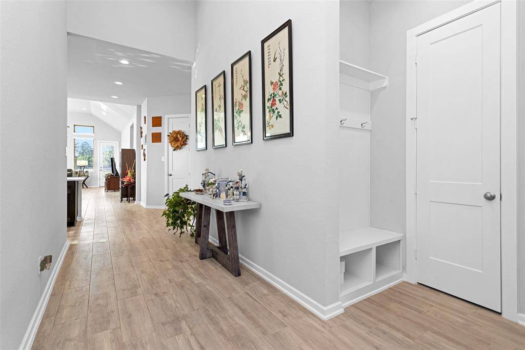 I absolutely love the long, grand entryway into the home, and those stunning floors are just beautiful