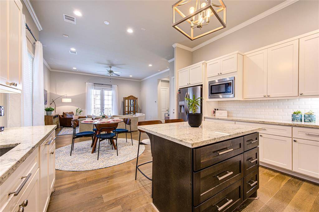 This designer kitchen is a true showpiece, featuring a large center island with GRanite countertops and ample seating, perfect for casual dining or entertaining. Open to the living and breakfast rooms, this kitchen is the ideal blend of style, performance, and connectivity.
