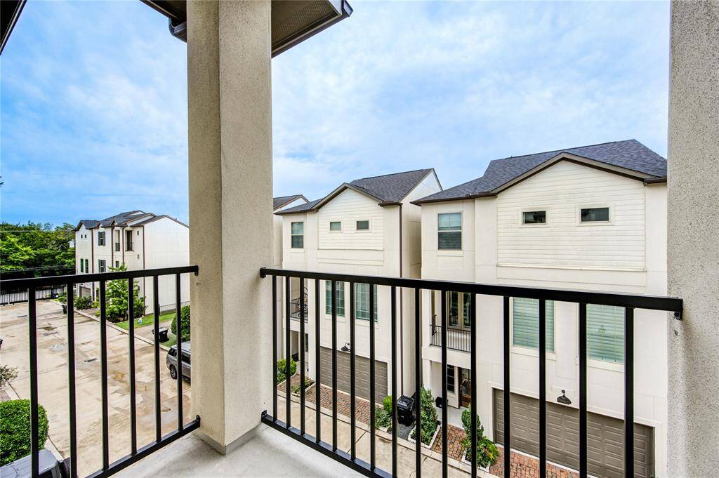 Charming second-story balcony overlooking the community green space—perfect for morning coffee or unwinding in the evening.
