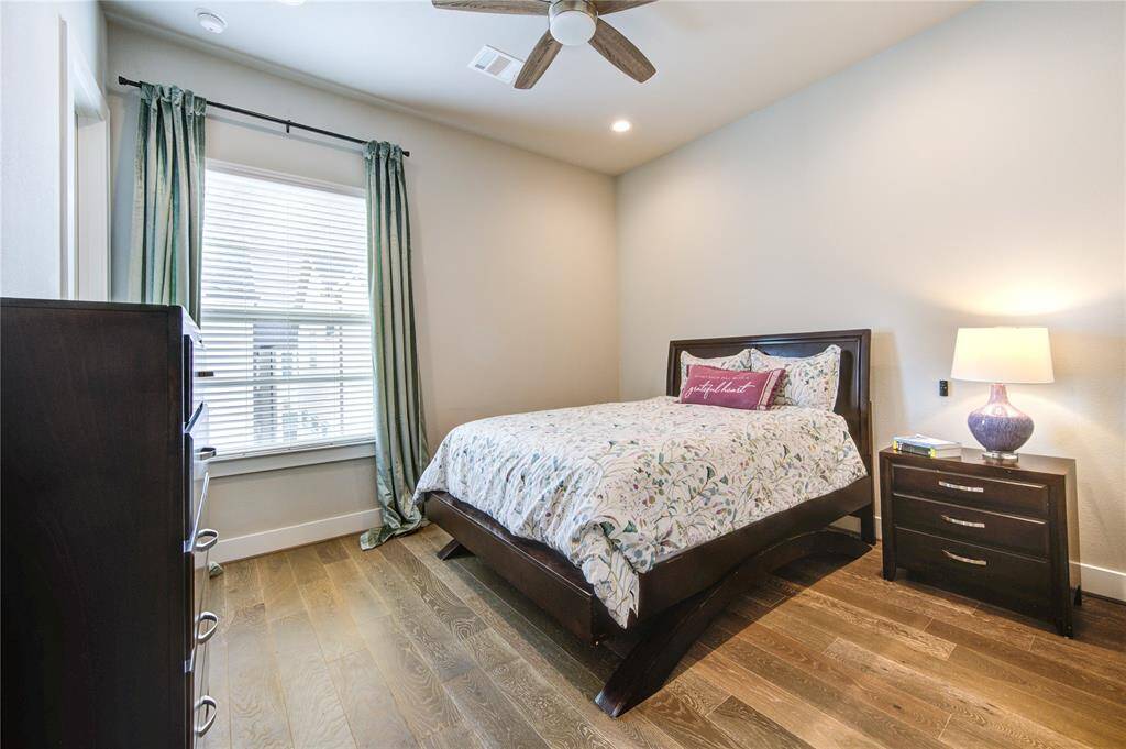 Bright and spacious guest suite with French Oak flooring, en-suite bathroom, and walk-in closet.