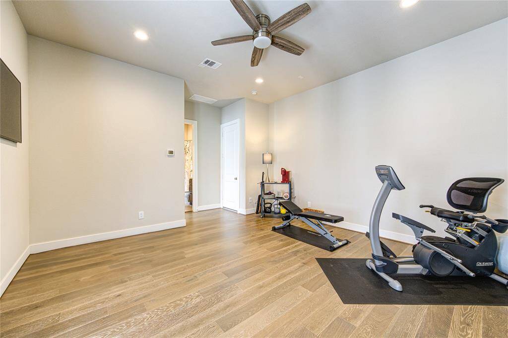 Another generously sized bedroom with beautiful natural light, hardwood floors, and a walk-in closet.