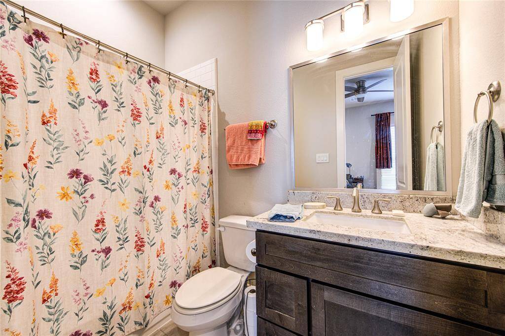 Private en-suite with clean, modern finishes and a tub/shower combo.