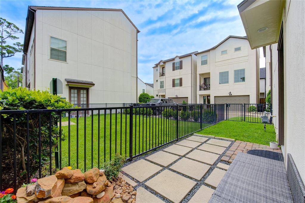 A rare find—this private side yard offers lush green space perfect for pets, play, or outdoor entertaining, with added privacy from the lack of a right-side neighbor.