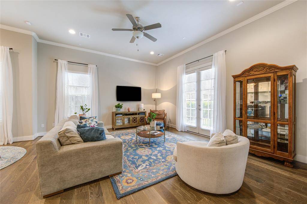 Bright and open living area featuring 11’ ceilings, French Oak floors, and abundant natural light streaming in through Low-E windows.