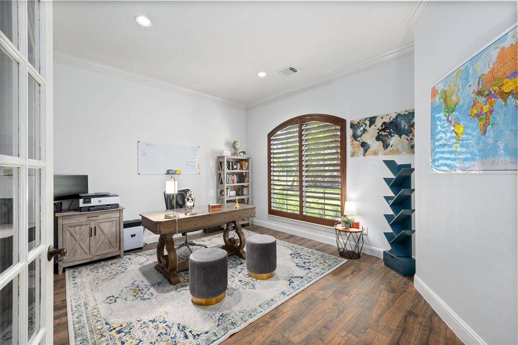 Just past the Formal Living Room is this great size Home Office.  This room can also easily be converted into a Bedroom with a wardrobe closet. Wall of custom shelving offers a space to show off your collectibles.