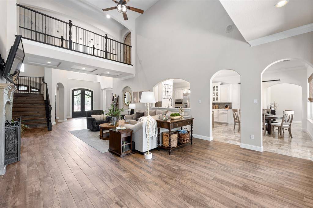 View looking back into the family room shows off the open layout with double catwalks overlooking this space. This view also shows off the openess of the living room into the breakfast area and kitchen.
