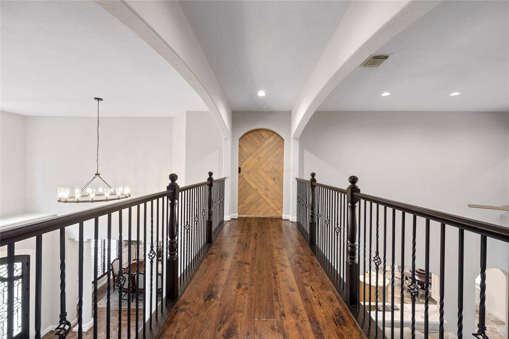 Just up the stairs, you'll be greeted by this view. Custom sliding barn doors at the end of each catwalk that overlooks the living room.