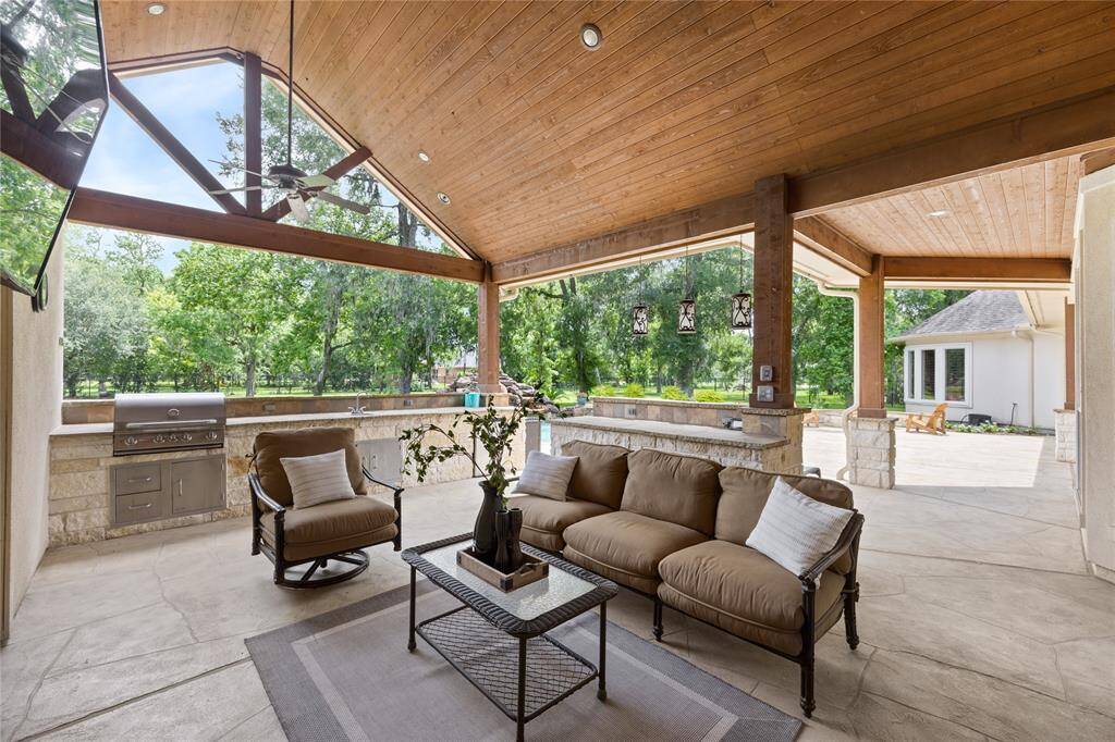 If over 5200 square feet of inside space isn't enough...this outdoor living space offers you a place to enjoy the outdoors all year round.  Catch a game while you are grilling burgers and hotdogs while overlooking the pool