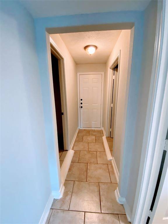 Hallway leading to bedrooms and in house utility room