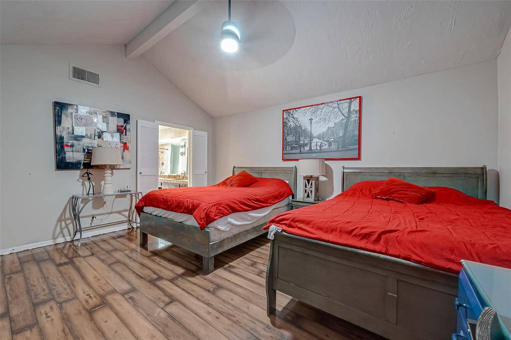 View of the primary bedroom, tall ceilings with an en suite bathroom.