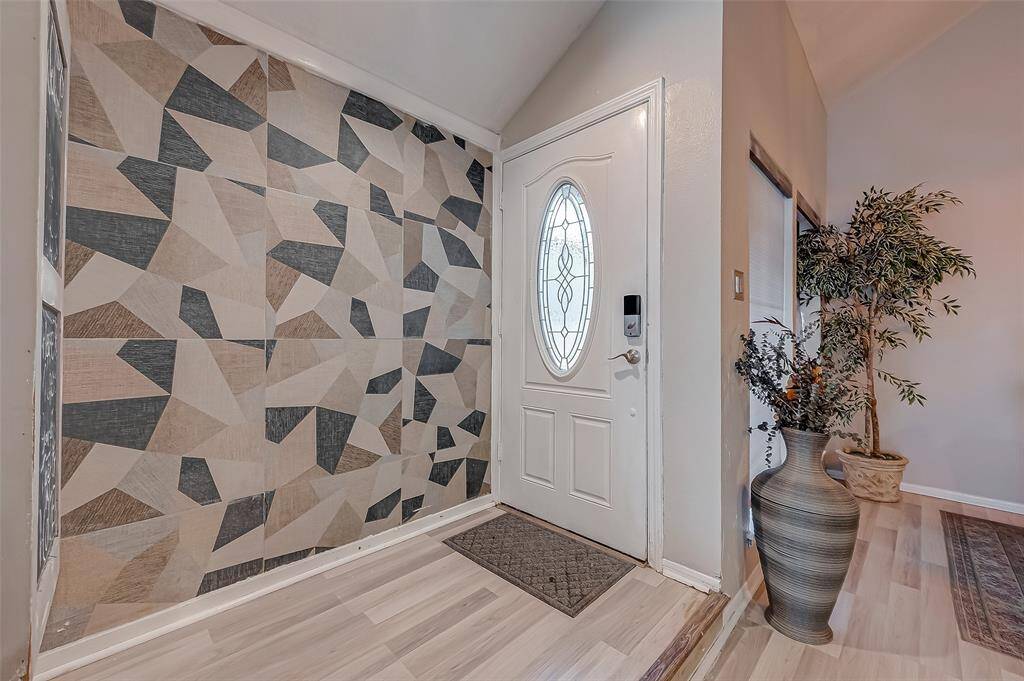 View of front door entrance, coat closet on the left hand side.
