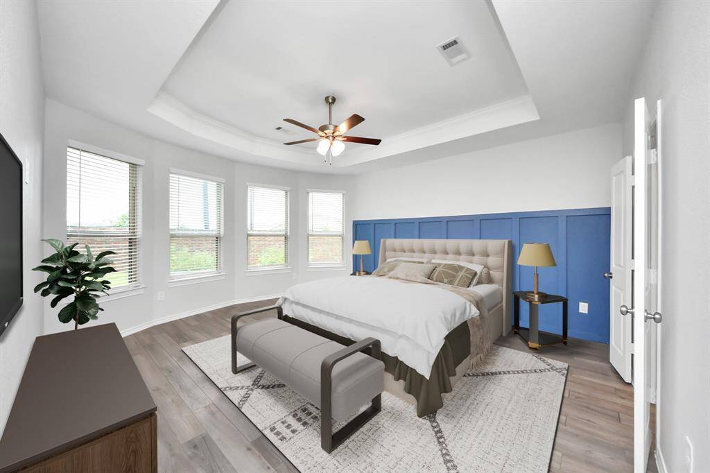 Stylish bedroom with vaulted ceiling, neutral carpet, and a bold wood accent wall.