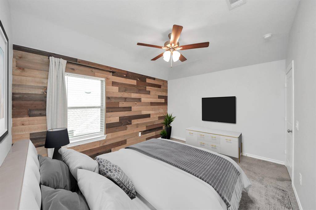 Unique bedroom with a dramatic black accent wall design, vaulted ceiling, and large window.
