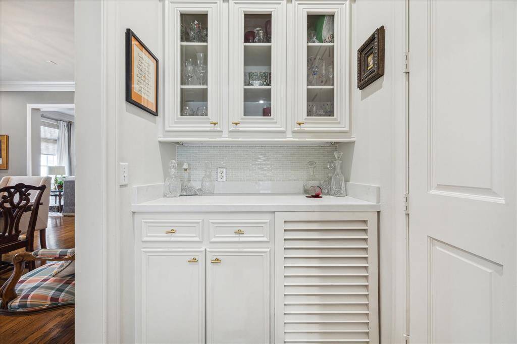 Dry bar with glass-front cabinetry.