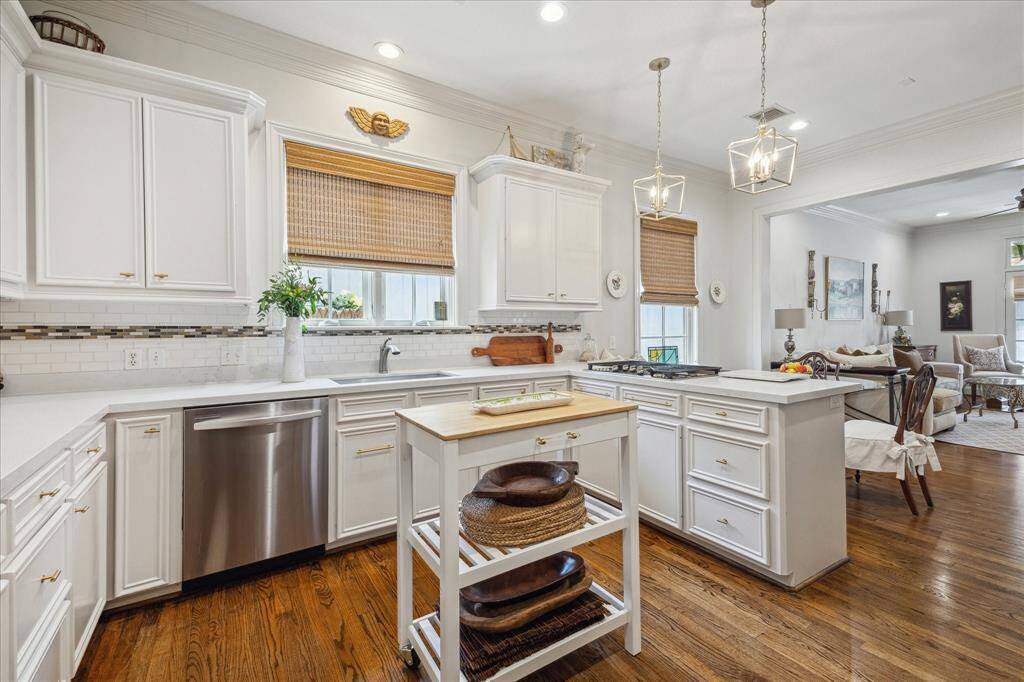 Chef's kitchen has been updated with quartz countertops, designer lighting and stainless appliances.