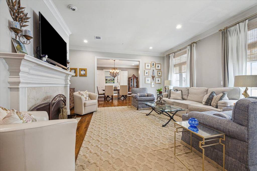Living room off entry with wood floors and stationary french doors off the back patio.