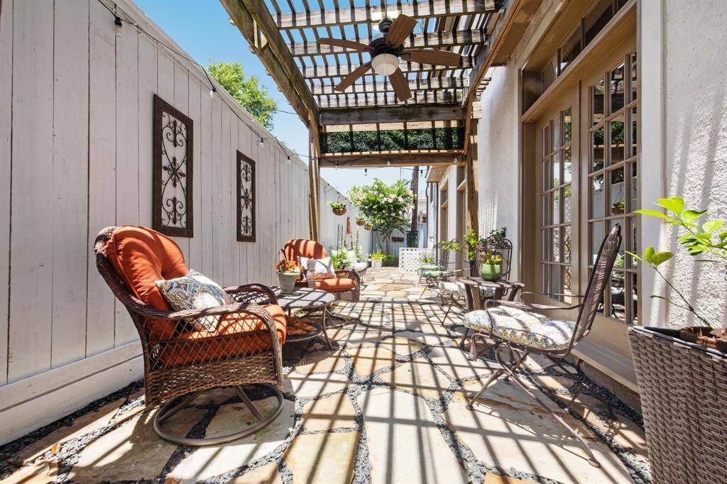 Ceiling fans and pergola help keep you cool on the back patio.