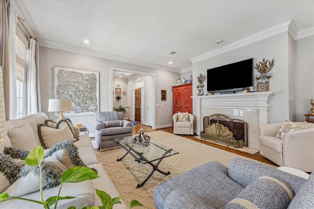 View of the light-filled living room looking back towards the front entry.
