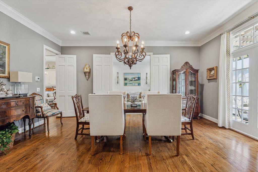 Formal dining room with double doors to family room and swing door to wet bar and kitchen.