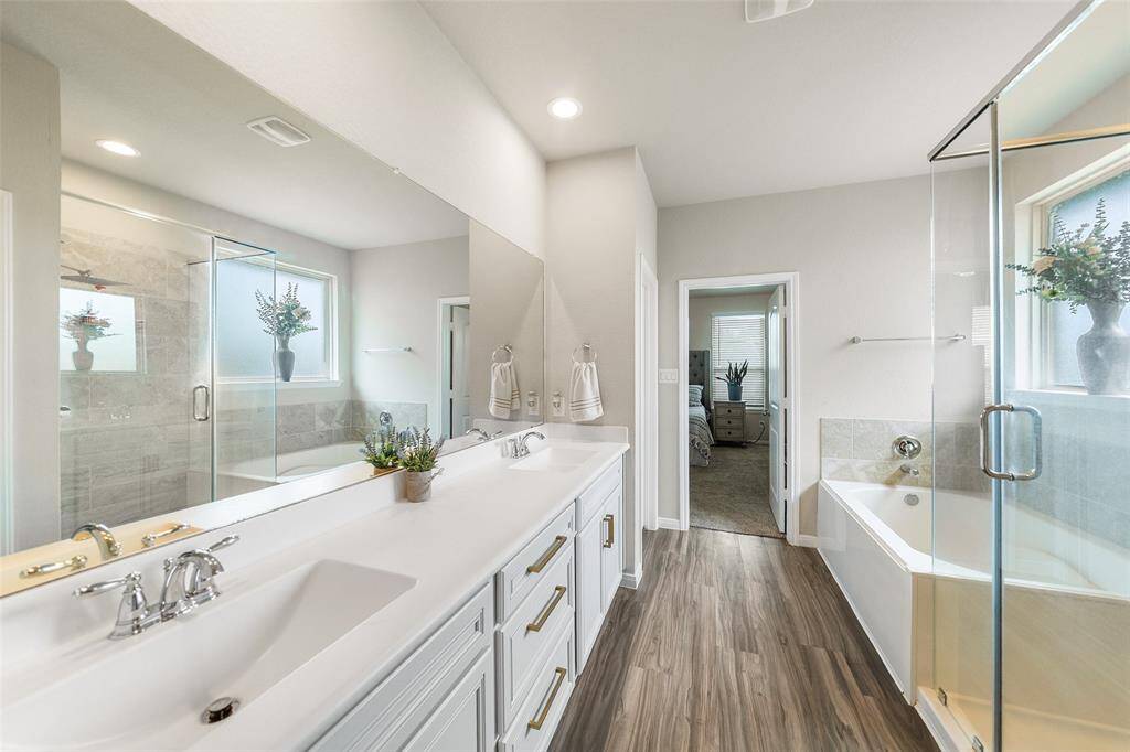 This bathroom features a modern design with dual sinks, a spacious vanity, and sleek fixtures.