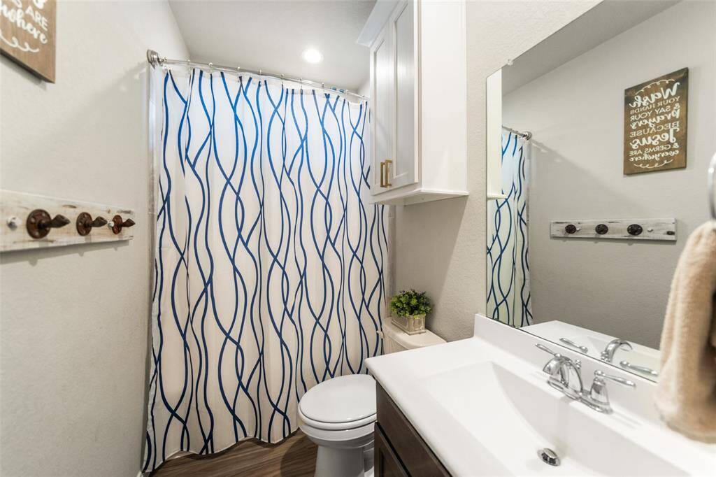 This bathroom features a modern design with wall-mounted storage.