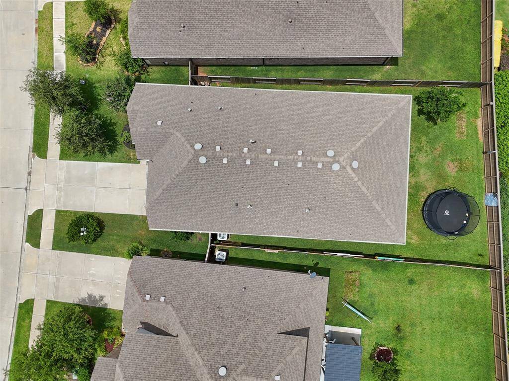 This aerial photo showcases the well-maintained roof and fenced backyard with no back neighbors.