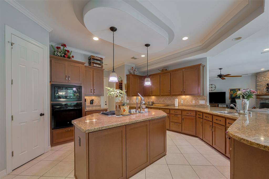 Noteworthy is the ample storage throughout this home. To the left, you'll find a spacious walk-in pantry—approximately 8 by 7 feet—conveniently located in the island kitchen.