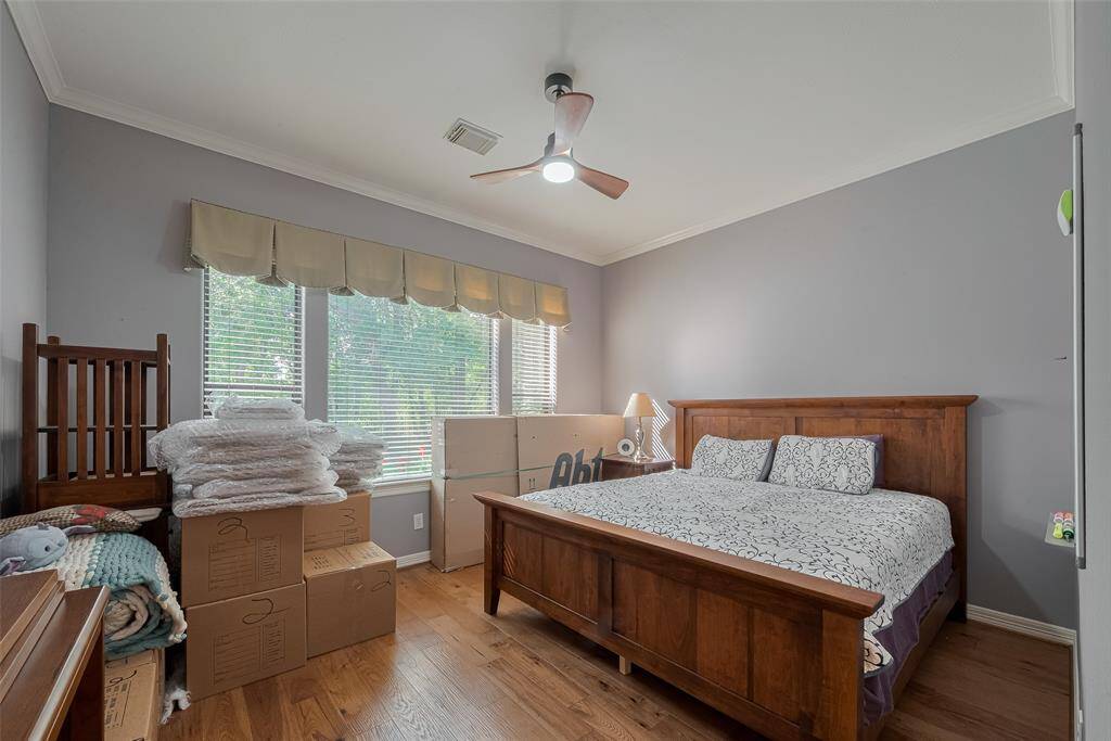 The downstairs guest or second bedroom offers its own ensuite full bath, showcases more of the custom red oak hardwood floors, and provides beautiful views of the golf course and backyard.