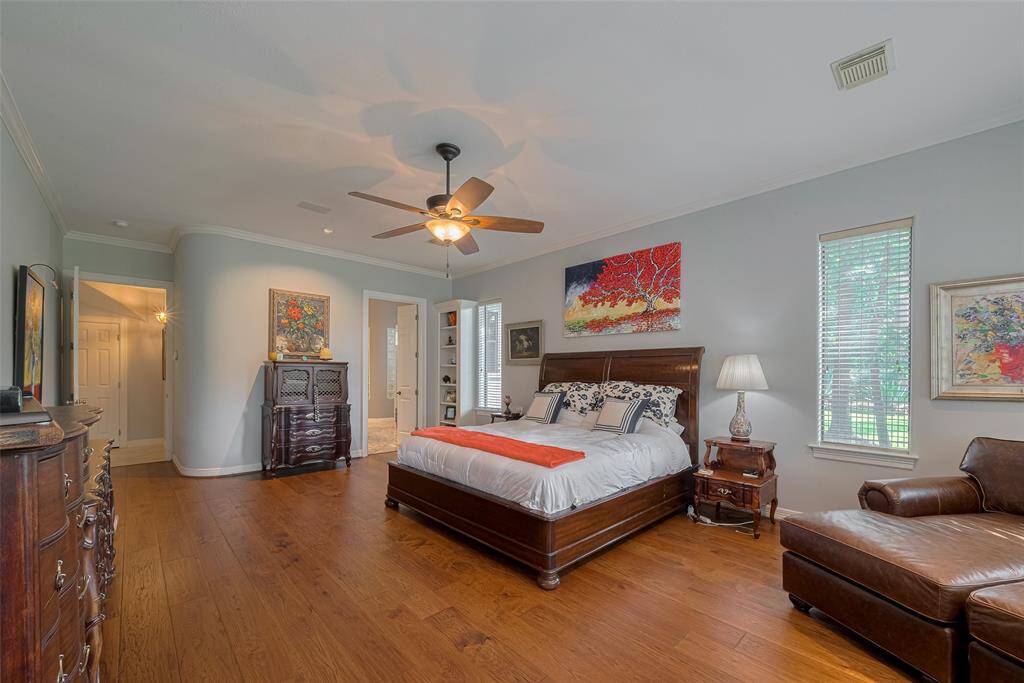 Featuring 10-foot ceilings, rounded corners, a ceiling fan, abundant windows, crown molding, and detailed trim—these are all custom touches from the renowned Pine Oak Homes builder.
