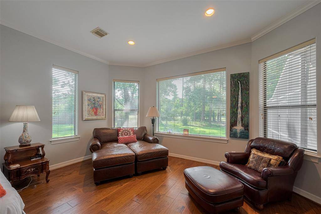 The primary bedroom stretches approximately 30 feet in length, providing ample space for a comfortable seating area with views overlooking the oversized backyard.