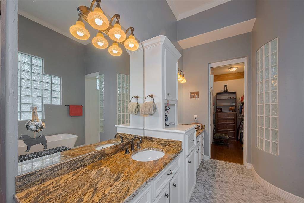 Updates in the primary bath include granite countertops, modern lighting fixtures, and upgraded plumbing hardware.