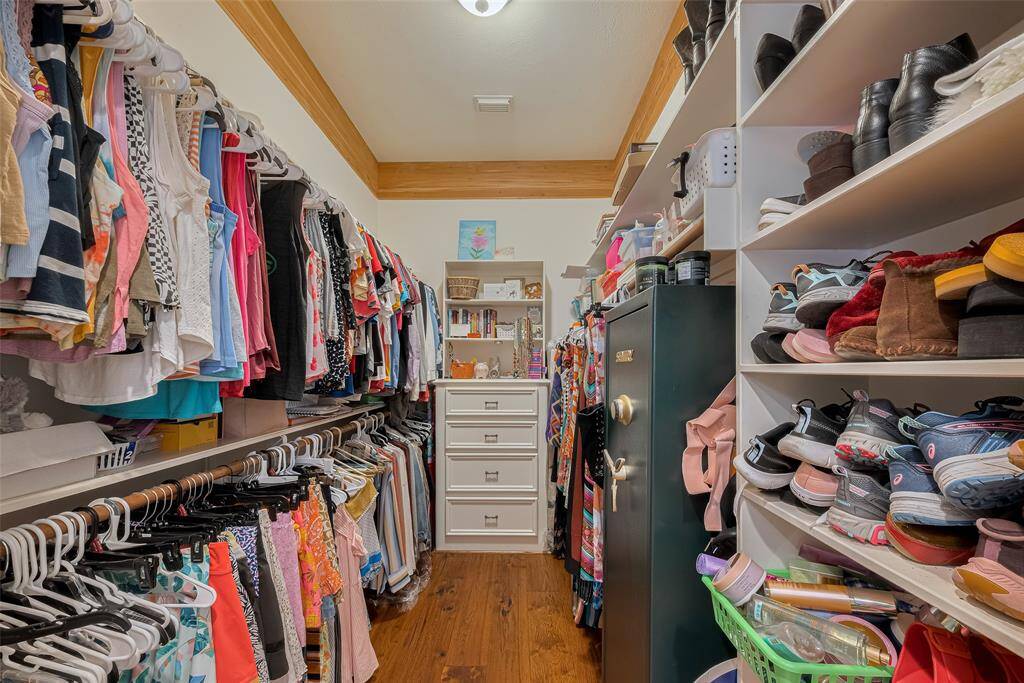 The first of two spacious walk-in closets is conveniently located off the primary bathroom.