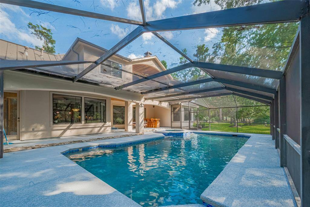 Bugs are NOT welcome here! Relax in your screened-in backyard oasis featuring a pool, spa, and a recently updated "cool temp" deck coating. The door on the far left provides access to the full bath.