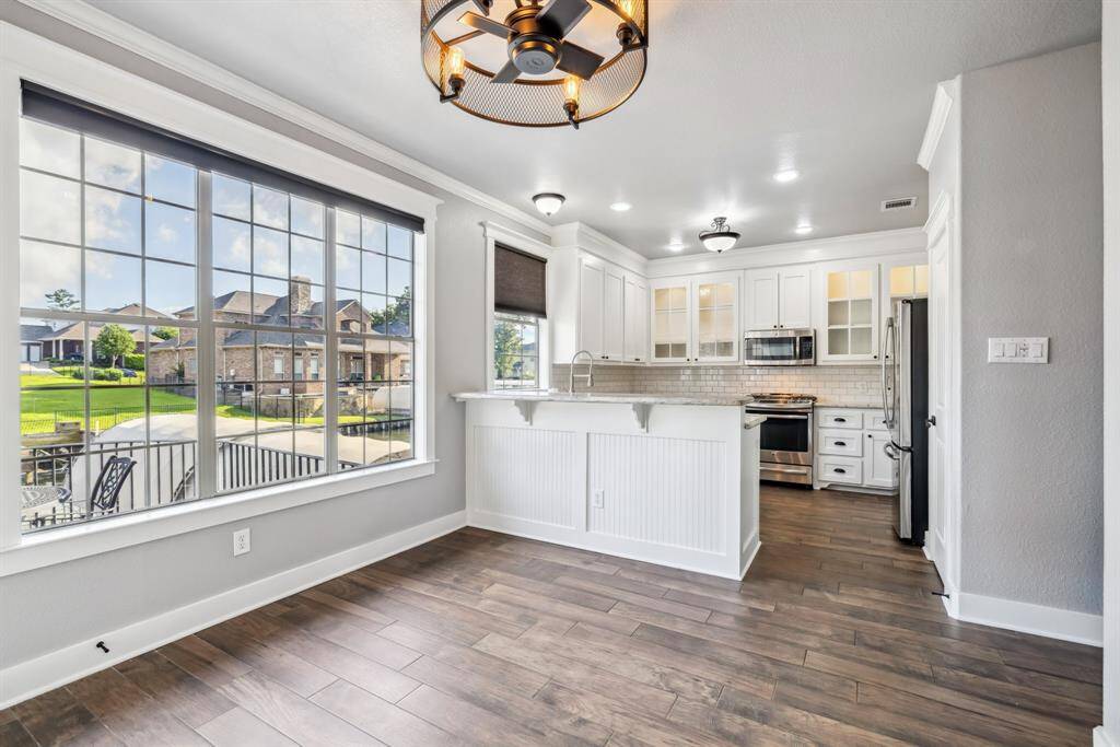 The breakfast room and kitchen have lots of natural light and overlook the water