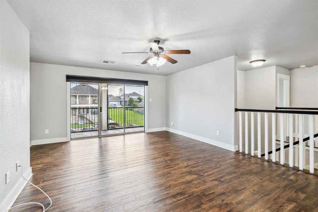 Oversized game room upstairs with view of the water and balcony access